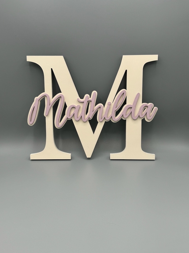 Weißer Holzbuchstabe M mit dem Namen Mathilda in Rosa